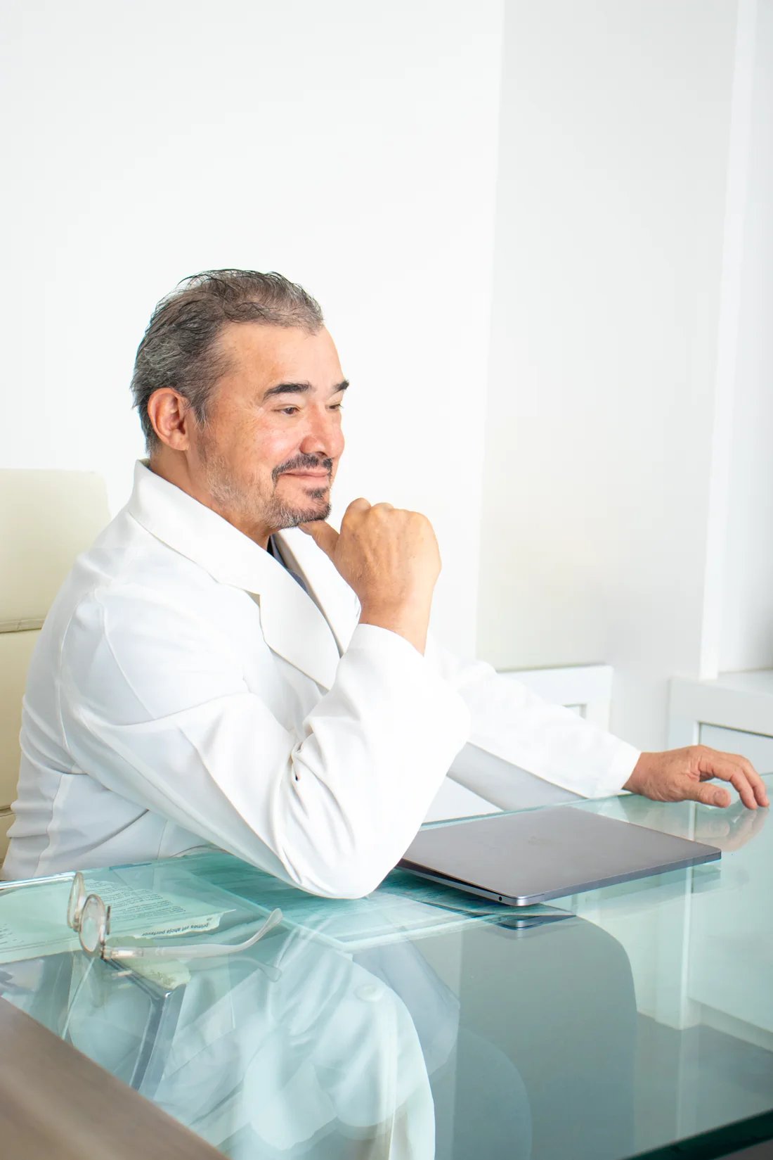 Dr. Quiroz reviewing a patient file at his clinic